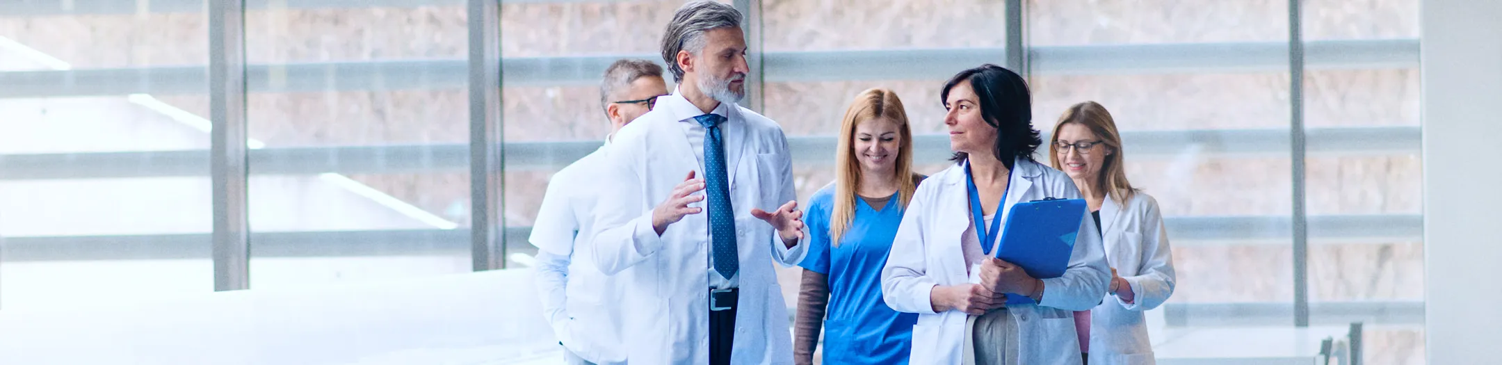 Medical team smiling in hospital corridor

